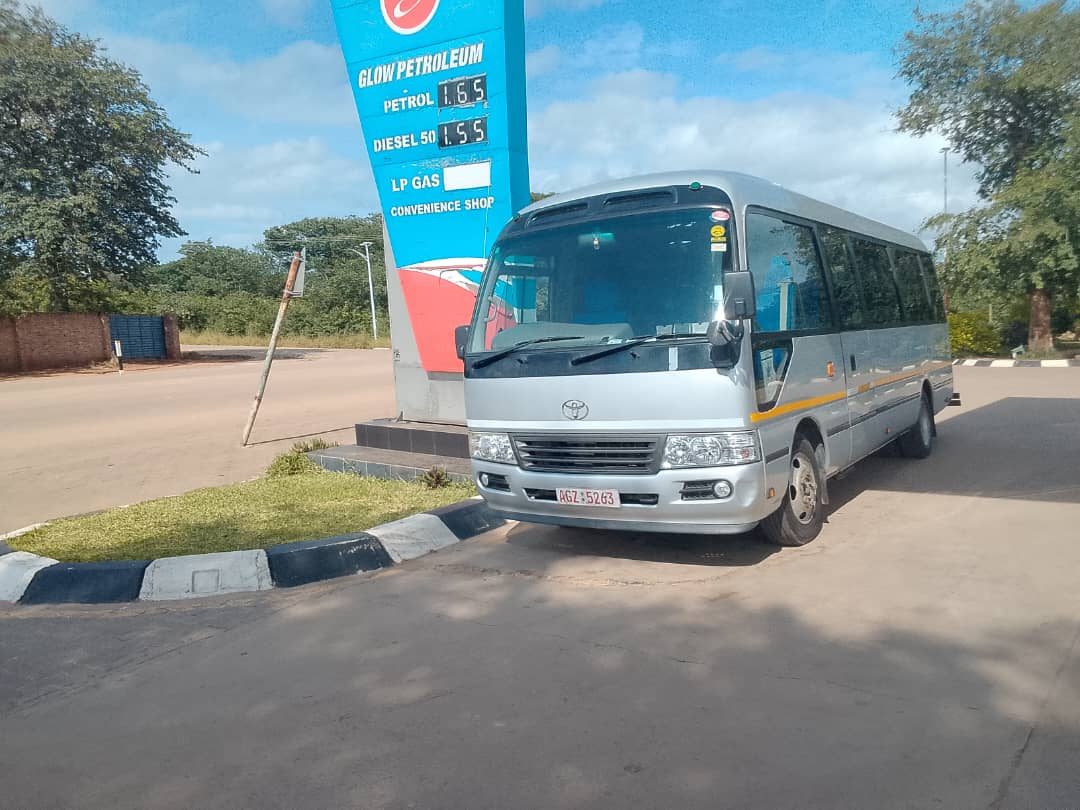 Bubbles Tours and Safaris fleet — Toyota Coaster and Nissan Serena